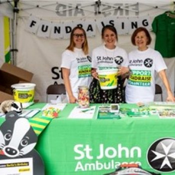 3 St John volunteers at a stall